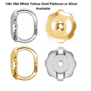 May include: Four earring backs in different metal finishes: white gold, yellow gold, platinum, and silver. The backs are all the same shape, with a rounded, scalloped edge.