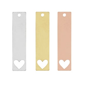 May include: Three rectangular metal tags with a heart-shaped cutout. The tags are silver, gold, and rose gold.
