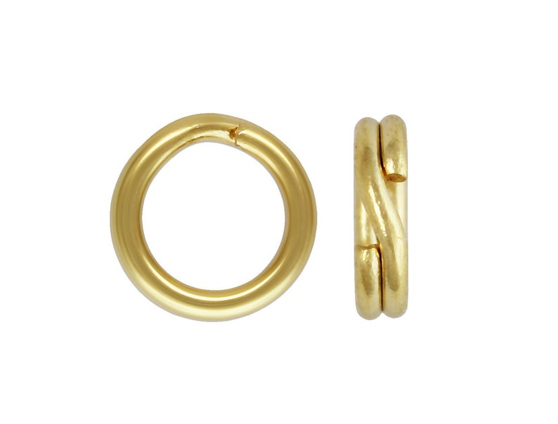 May include: Two gold-colored metal jump rings. One ring is open and the other is closed.