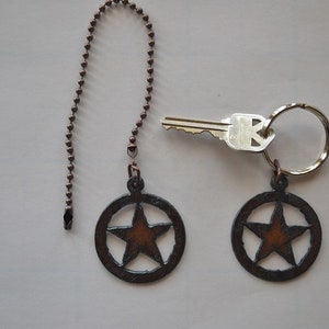 May include: Two rustic brown metal star-shaped fan pull chains with a silver key and key ring.