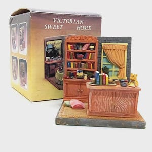 May include: A miniature Victorian Sweet Home diorama. The scene features a bookcase, desk, window with curtains, and a small teddy bear. The box reads "Victorian Sweet Home".