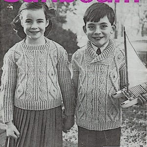 May include: A vintage black and white image featuring two children in knitted sweaters. The girl wears a pleated skirt, and the boy holds a toy sailboat. The word "Sunbeam" is at the top, and the text "No. 252 6d." is at the bottom.