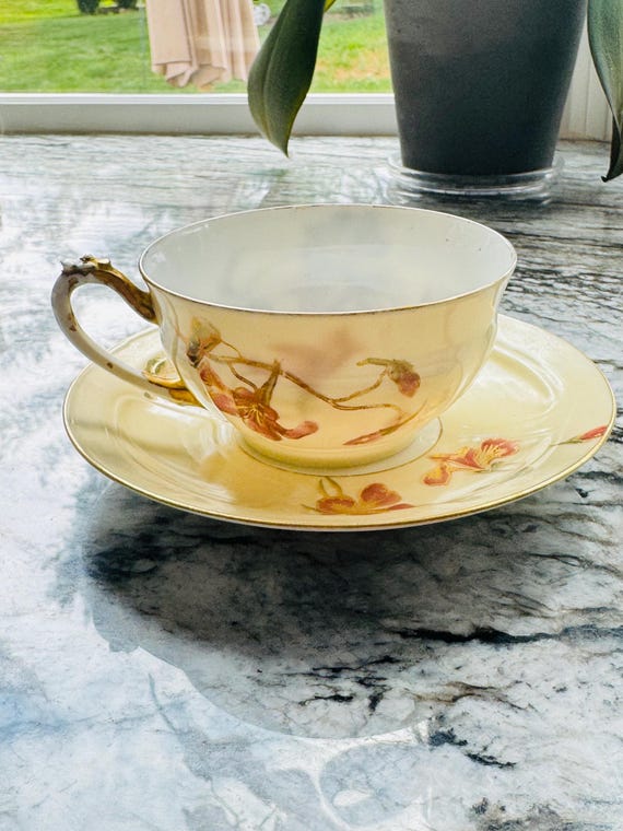 Antique Limoges Teacup and Saucer Set D&C France Delinieres Porcelain Hand Painted Orange Orchid Lily on Yellow Late 19th Century. Imperfect