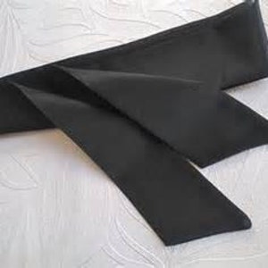 May include: A black satin ribbon with a long, flowing tail. The ribbon is tied in a simple knot.