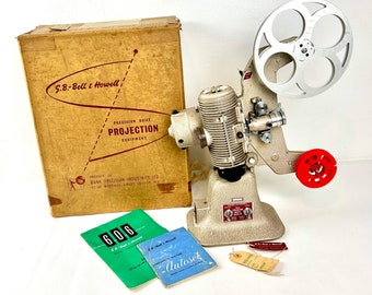 Vintage 1950s Cine Projector- 8mm Bell & Howell model 606 in its original cardboard boxed packaging Prop