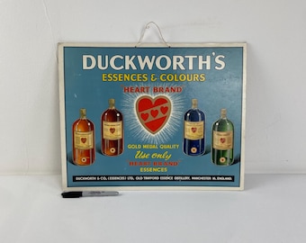 A genuine original advertisement board for 'Duckworth's essences and colours "heart brand. c1950s