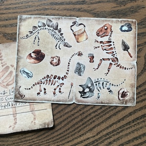 May include: A vintage-style postcard featuring a collection of dinosaur skeletons, including a stegosaurus, a triceratops, and a brachiosaurus. The postcard has a brown background with a distressed texture and includes various other fossil-related imagery.