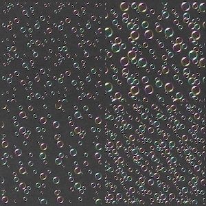 May include: A black background with a pattern of iridescent bubbles of various sizes. The bubbles are scattered randomly across the background.