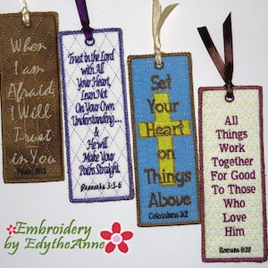 May include: Four embroidered bookmarks with religious quotes. The bookmarks are rectangular with decorative stitching and ribbon attachments. Each bookmark features a different colour scheme and text, including Bible verses.
