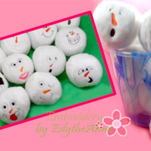May include: A collection of white plush snowballs with embroidered faces, some with orange carrot noses and black eyes. One snowball has a black mask. A blue bucket is filled with similar snowballs. The background is pink and green.
