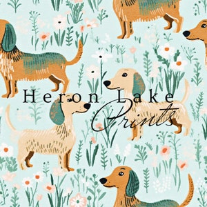 May include: A seamless pattern featuring a repeating design of brown and green dachshunds with white flowers and green foliage on a light blue background. The text "Heron Lake Prints" is visible in the center of the design.
