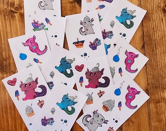 May include: A set of 12 axolotl stickers featuring different colors and designs. The axolotls are wearing party hats and have different accessories like cupcakes, balloons, and gifts. The stickers are printed on white paper.