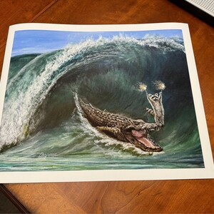 My wave raccoon surfing on a large alligator sea Croc. Artist signed print. Multiple variations. Great gift for raccoon fans. Kip and Cyrus image 5