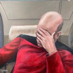 Captain Jean-Luc Picard with face palm on the TV show Star Trek.Patrick Stewart is wearing his famous Red and Black Uniform as Captain Picard.