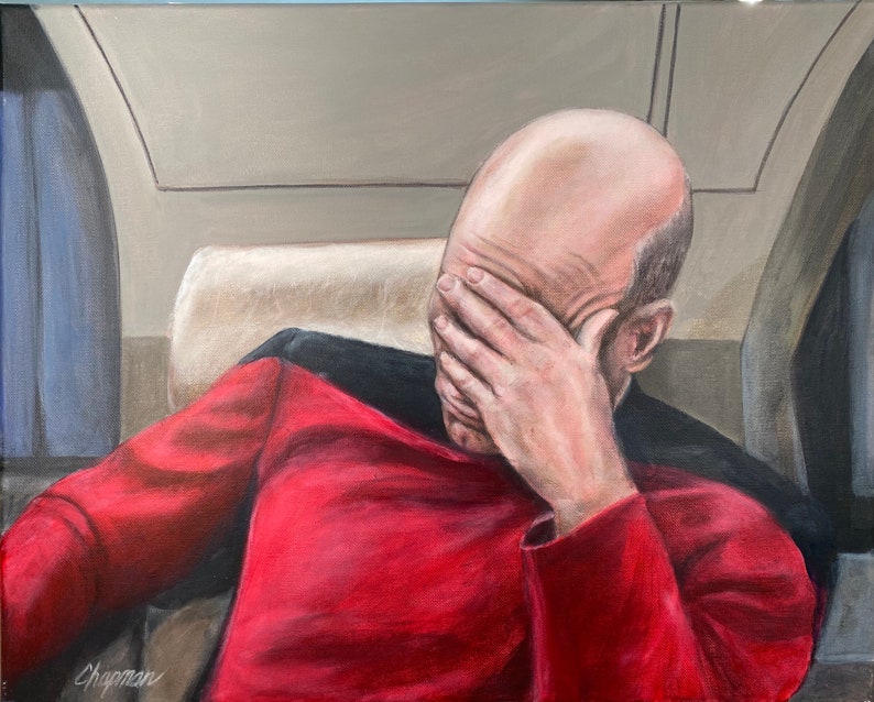 Captain Jean-Luc Picard with face palm on the TV show Star Trek.Patrick Stewart is wearing his famous Red and Black Uniform as Captain Picard.