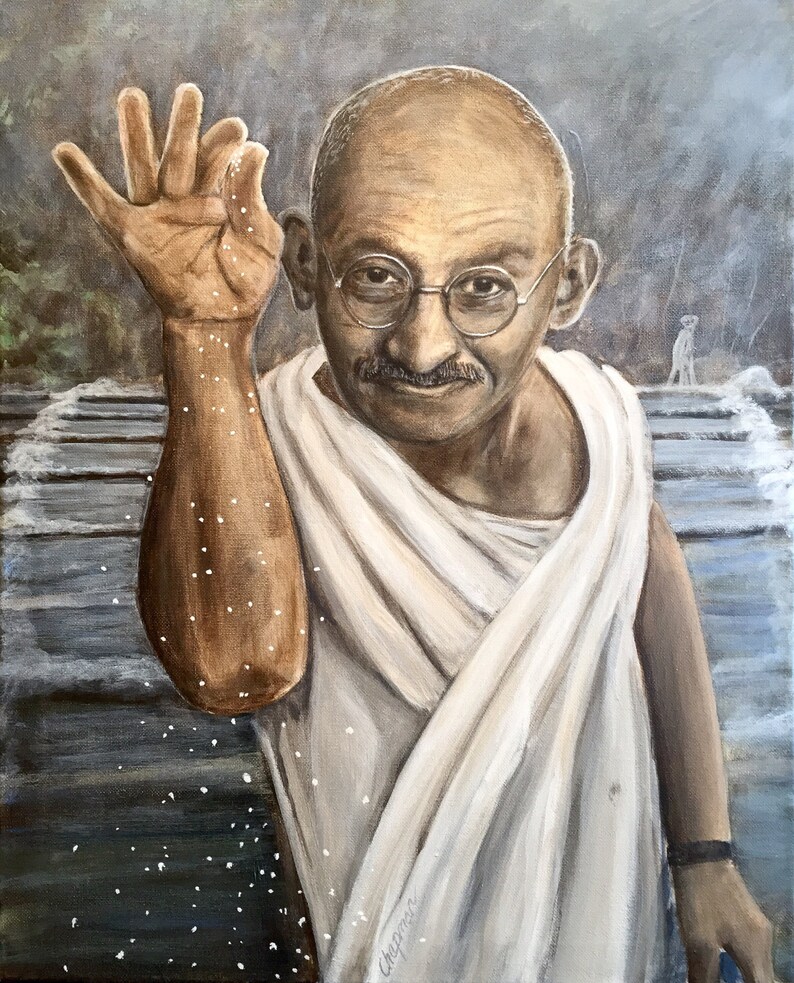 Gandhi sprinkles a pinch of salt wearing his white Khadi and glasses