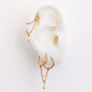 Doppelte Piercingkette und Kristall für Helix-Conch-Piercing aus goldenem Edelstahl. Ohrkettenpiercing oder verbundene Creolen