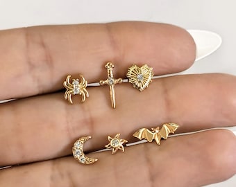 Sword bat spider sun moon heart piercing .  Helix tragus lobe snug conch piercing in stainless steel . Gold bar earring piercing halloween