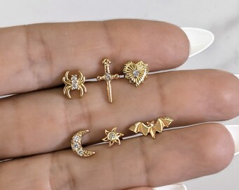 Sword bat spider sun moon heart piercing .  Helix tragus lobe snug conch piercing in stainless steel . Gold bar earring piercing halloween