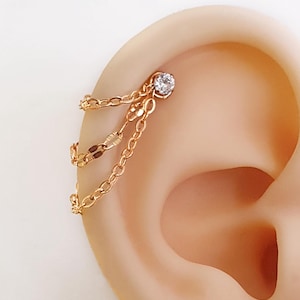 Gold triple chain for huggies or helix industrial piercing . Stainless steel chain for cartilage with cristal piercing