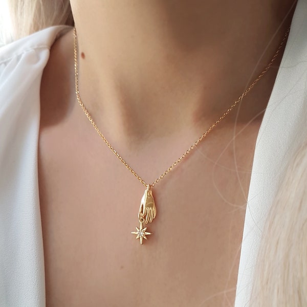 Destiny necklace - Small hand holding a star set on a dainty chain