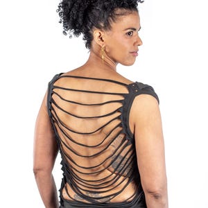 May include: A black sleeveless shirt with a unique design featuring multiple horizontal strips of fabric cut out across the back. The shirt is made of a soft, comfortable material.