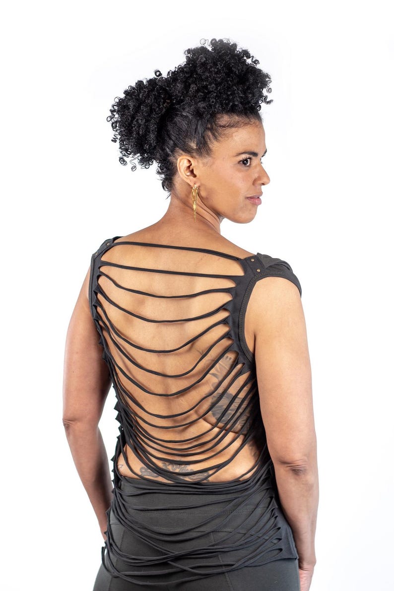 May include: A black sleeveless shirt with a unique design featuring multiple horizontal strips of fabric cut out across the back. The shirt is made of a soft, comfortable material.