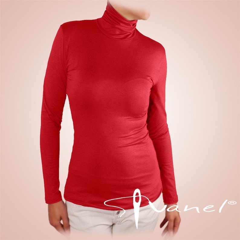 May include: A red long-sleeved turtleneck shirt. The shirt is made of a soft, stretchy fabric and has a fitted silhouette.