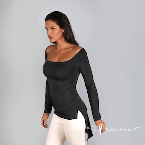 May include: A black long-sleeved shirt with a scoop neck and a high-low hemline. The shirt has a side slit on the right side.
