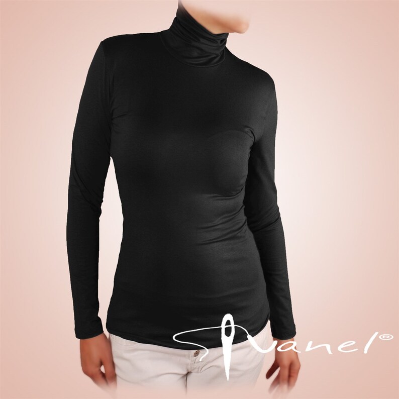May include: A black long-sleeved mock neck shirt. The shirt is made of a soft, stretchy fabric and has a fitted silhouette.