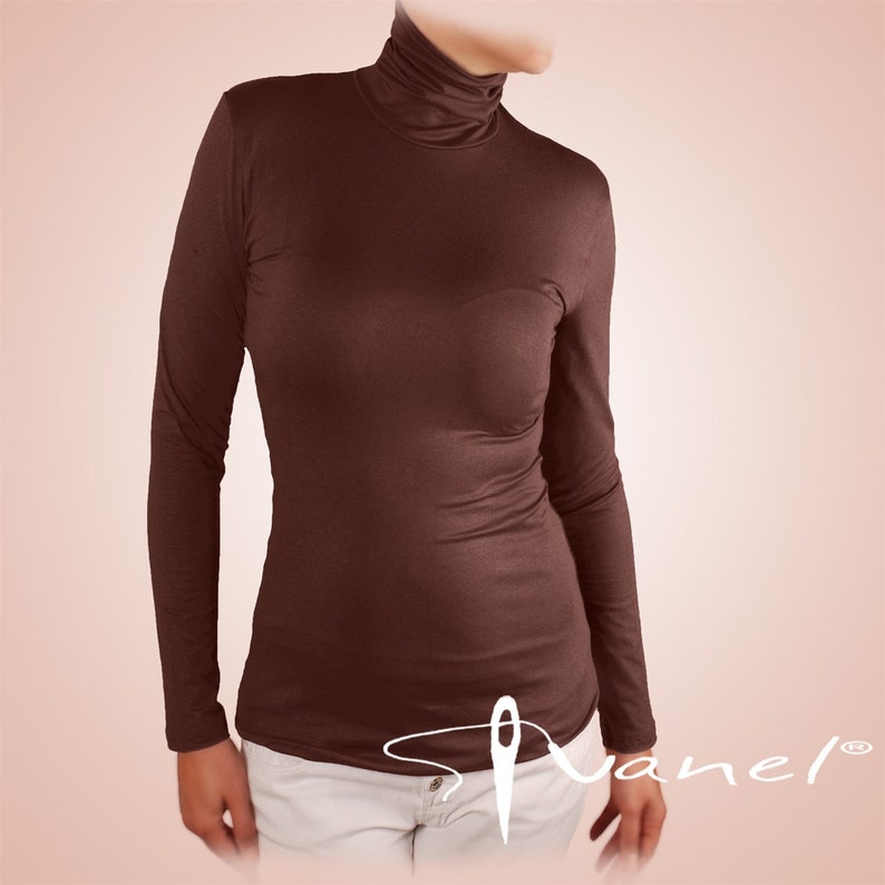 May include: A brown long-sleeved turtleneck shirt. The shirt is made of a soft, stretchy fabric and has a fitted silhouette.