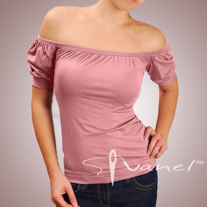 May include: A pink off-the-shoulder top with short sleeves and a fitted silhouette. The top has a simple design and is made of a soft, stretchy fabric.