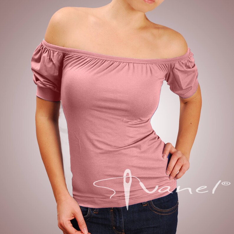 May include: A pink off-the-shoulder top with short sleeves and a fitted silhouette. The top has a simple design and is made of a soft, stretchy fabric.