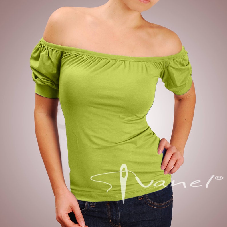 May include: A lime green off-the-shoulder top with short sleeves. The top is made of a soft, stretchy fabric and has a relaxed fit.