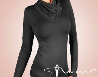 May include: Black long-sleeve top with a cowl neck design. The top features a fitted silhouette and a draped neckline. The brand name "Stanel" is printed in white script on the lower front of the top.