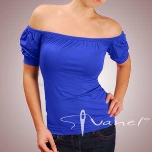 May include: A royal blue off-the-shoulder top with short sleeves. The top is made of a soft, stretchy fabric and has a relaxed fit.