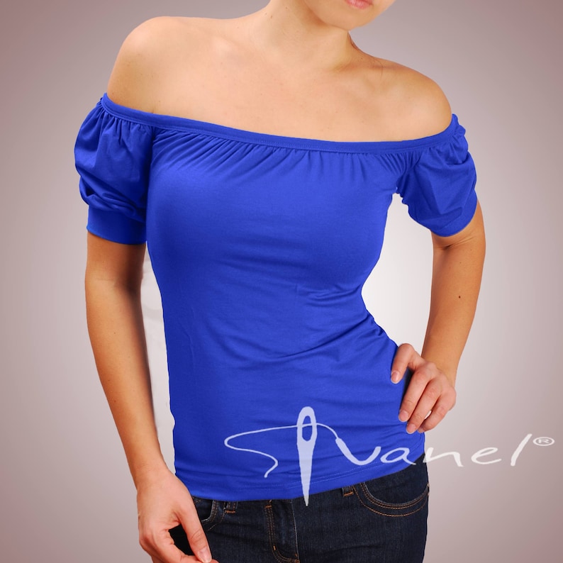 May include: A royal blue off-the-shoulder top with short sleeves. The top is made of a soft, stretchy fabric and has a relaxed fit.