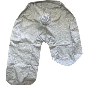 May include: A gray U-shaped pregnancy pillow with a textured fabric.