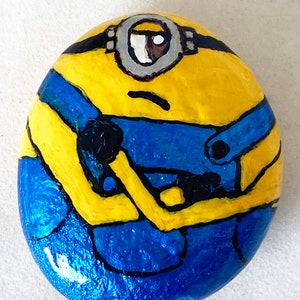 This is the one-eyed Minion, Stuart, from the Despicable Me Movies. He is one of the top 3 minions in the franchise, along with Bob & Kevin