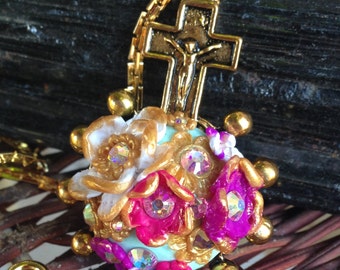 Flowers Beneath the Gold Cross Pendant