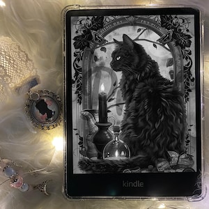 May include: A black and white illustration of a black cat sitting on a table with a candle and a bottle. The image is on a Kindle e-reader.
