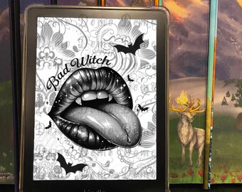 May include: A black and white Kindle e-reader with a screen displaying a graphic of a mouth with fangs and a tongue sticking out. The text "Bad Witch" is above the mouth. The background is a white and gray floral pattern with bats.