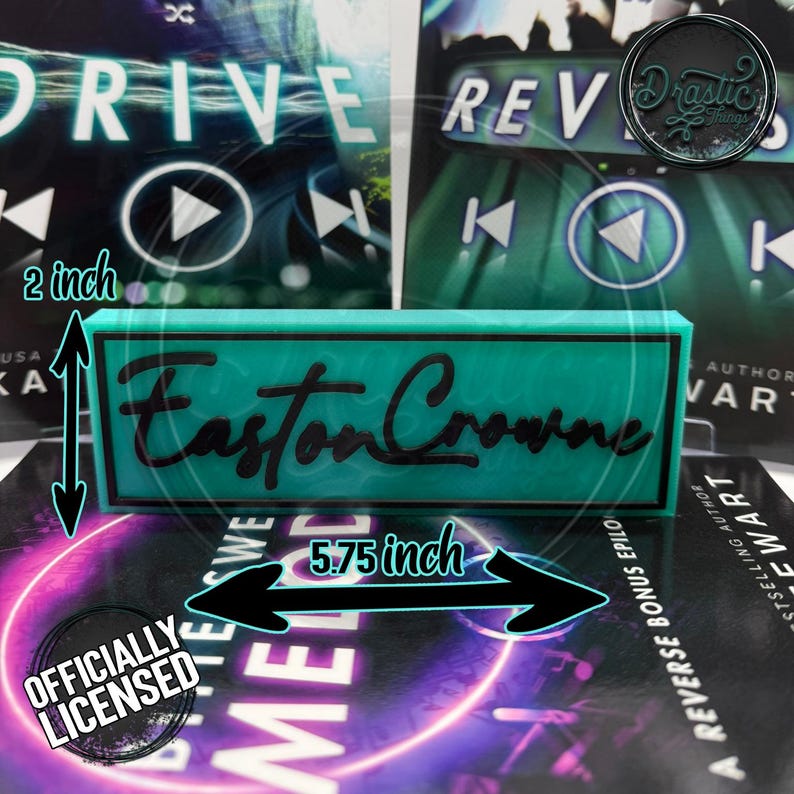 May include: A teal rectangular sign with the name "Easton Crowne" in black script. The sign is 5.75 inches long and 2 inches high. The words "Officially Licensed" are printed on the bottom left. The background includes book covers.