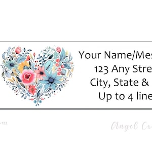 May include: A white label with a floral heart design in shades of blue, pink, and yellow. The label has space for a name, address, and up to four lines of text. The text on the label reads "Your Name/Message 123 Any Street City, State & Zip Up to 4 lines".