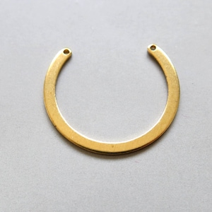 May include: Gold-toned metal ring with two holes, perfect for adding to jewelry projects.