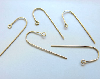 May include: Five gold-toned earring hooks, each with a small loop at the top. The hooks are made of metal and are designed for attaching earrings.