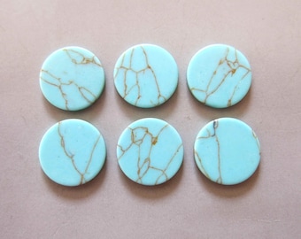 May include: Six round turquoise cabochons with gold veining. The cabochons are approximately 2.5 cm in diameter.