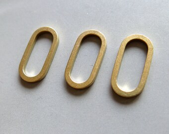 May include: Three gold-colored metal oval rings. The rings are smooth and have a shiny finish.