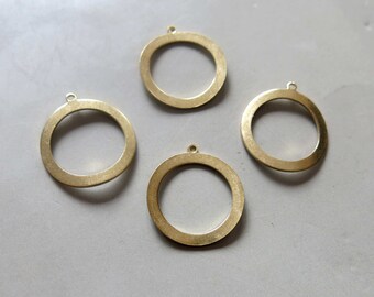 May include: Four gold-colored metal rings with a smooth finish. Each ring has a small loop at the top for hanging.