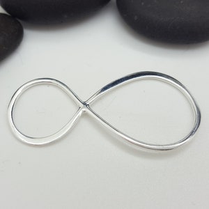May include: A silver infinity symbol charm, a simple and elegant design.
